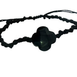 Gold cord bracelet with clover and faceted stone