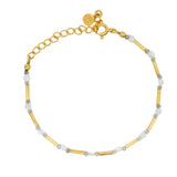 Golden bracelet with tubes and faceted stones