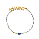 Gold rod bracelet and natural stones