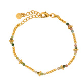Gold bracelet with guilloche patterns and stones