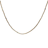 Necklace with golden rods and natural stones