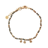 Bracelet with guilloche stones and flower tassels