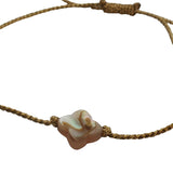 Gold cord bracelet and mother-of-pearl clover