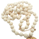 Collier doré médaillon avec oeil en nacre perles en os 90 cm