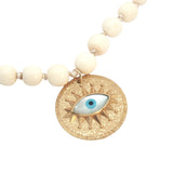 Collier doré médaillon avec oeil en nacre perles en os 90 cm