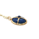 Gold necklace with cabochon stone and gold cage