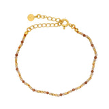 Golden bracelet with stones and golden discs
