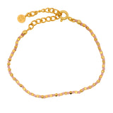 Bracelet doré avec perles martelées dorées et noeuds roses