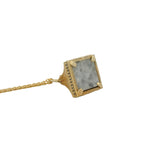 Gold necklace with bell pendant, zircons and stone