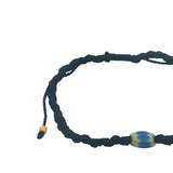 Navy blue cord bracelet with yellow and blue African pearl