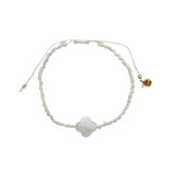 Gold cord bracelet with clover and faceted stone