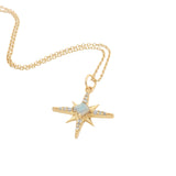 Gold necklace with compass rose pendant, stone and zircons