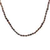 Golden necklace with elongated coconut wood beads