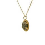 Gold necklace with oval stone pendant and balls