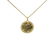 Gold necklace with oval stone pendant and balls