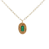 Gold necklace with textured oval pendant and stone