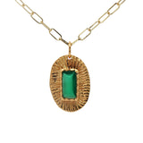 Gold necklace with textured oval pendant and stone