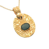 Gold necklace with engraved flower and stone pendant