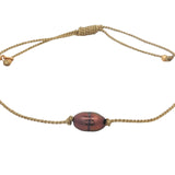 Bracelet doré avec perle de culture grise