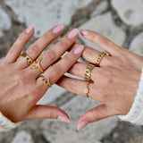 Gold ring with hollow eye and zircons