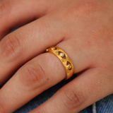 Gold ring with hollow eye and zircons