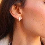 Wide straight gold hoop earrings with zircons
