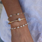 Wire bracelet with oval stones and golden discs
