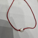 Red thread and mother-of-pearl heart