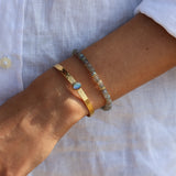 Hammered gold rush and oval natural stone