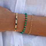 Textured gold bangle with flowers and 3 stones