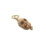 Charms doré tête de mort taillée dans de l'os