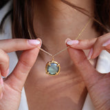 Gold necklace with round stone pendant set with 4 claws