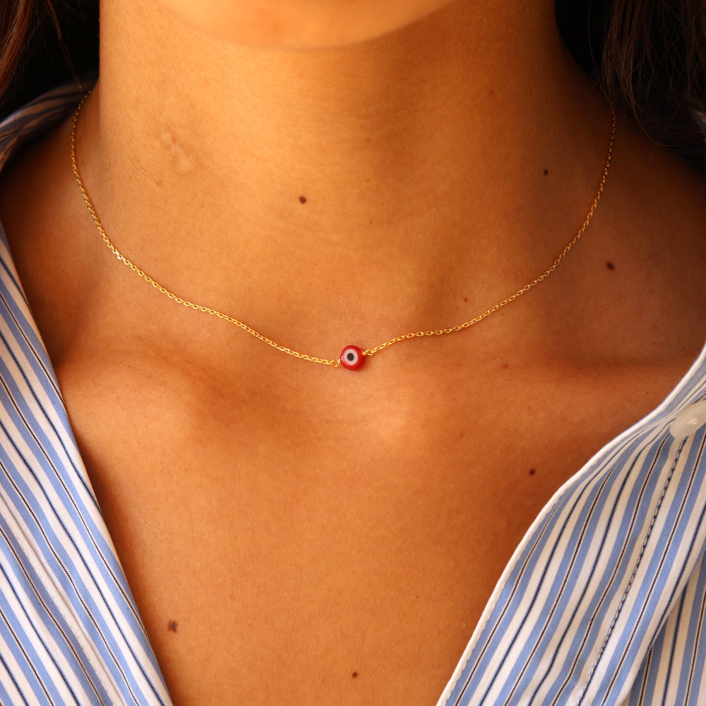 Golden necklace with red lucky eye