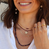 Gold necklace with hammered flower medal and zircons