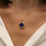 Gold necklace with round stone pendant set with 4 claws