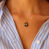 Gold necklace with gold cage stone pendant