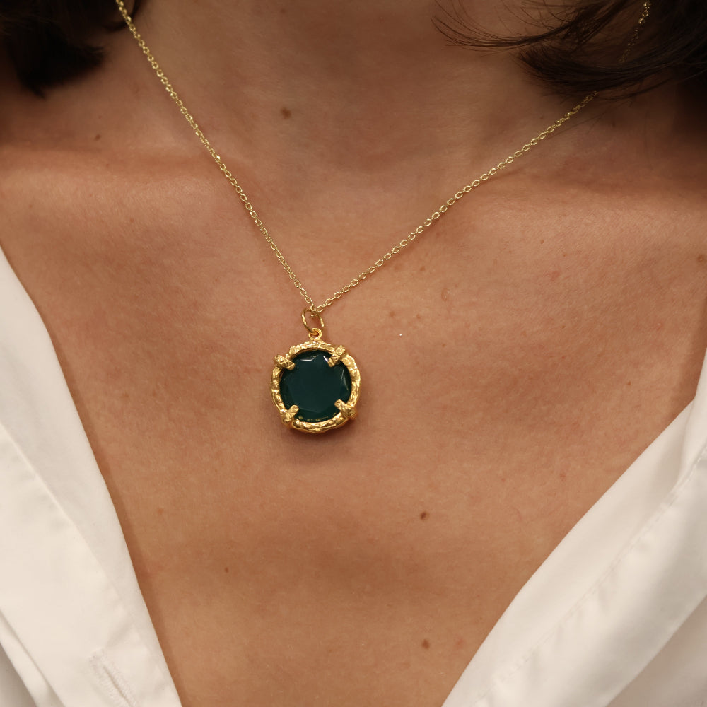Gold necklace with round stone pendant set with 4 claws