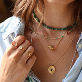 Gold necklace and striated and stone pendant