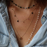 Golden necklace with rectangular mesh and stone tassels