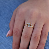 Gold ring with openwork eye, zircons and labradorite