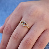 Gold ring with openwork eye, zircons and labradorite