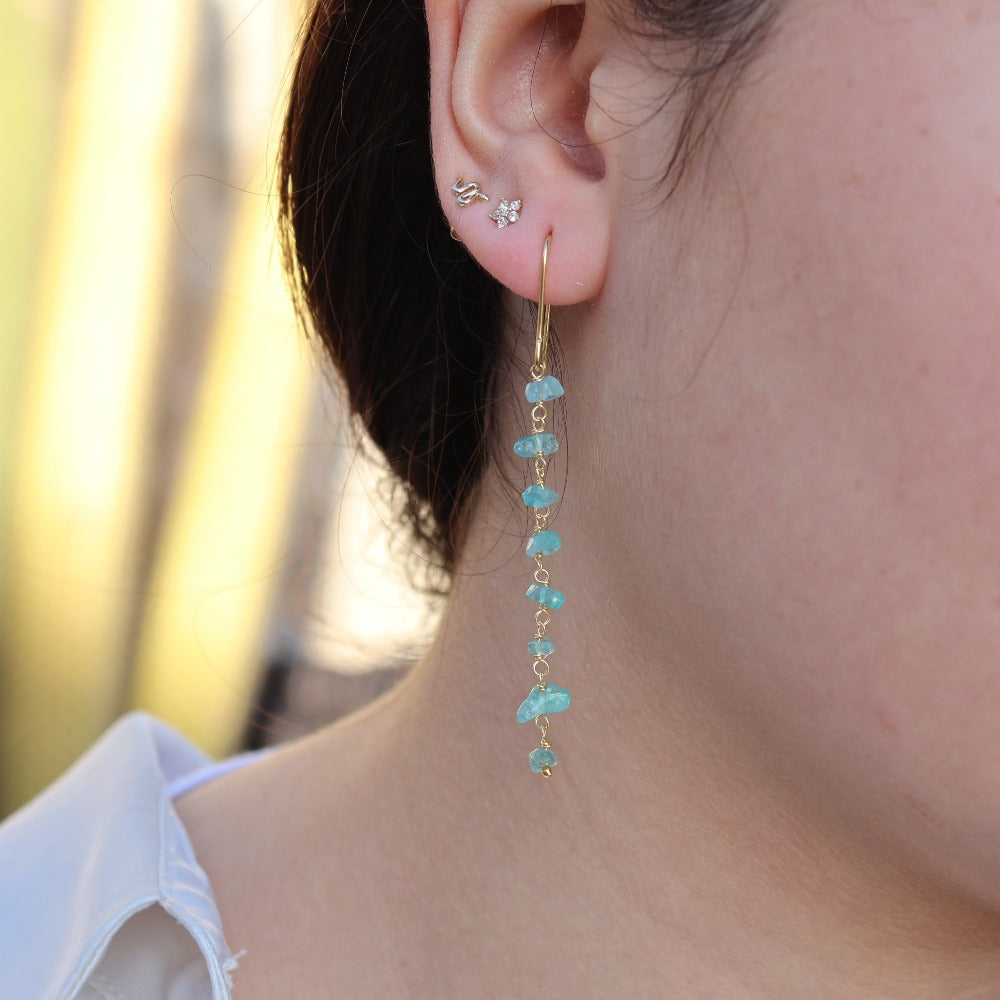 Golden earrings and raw stones