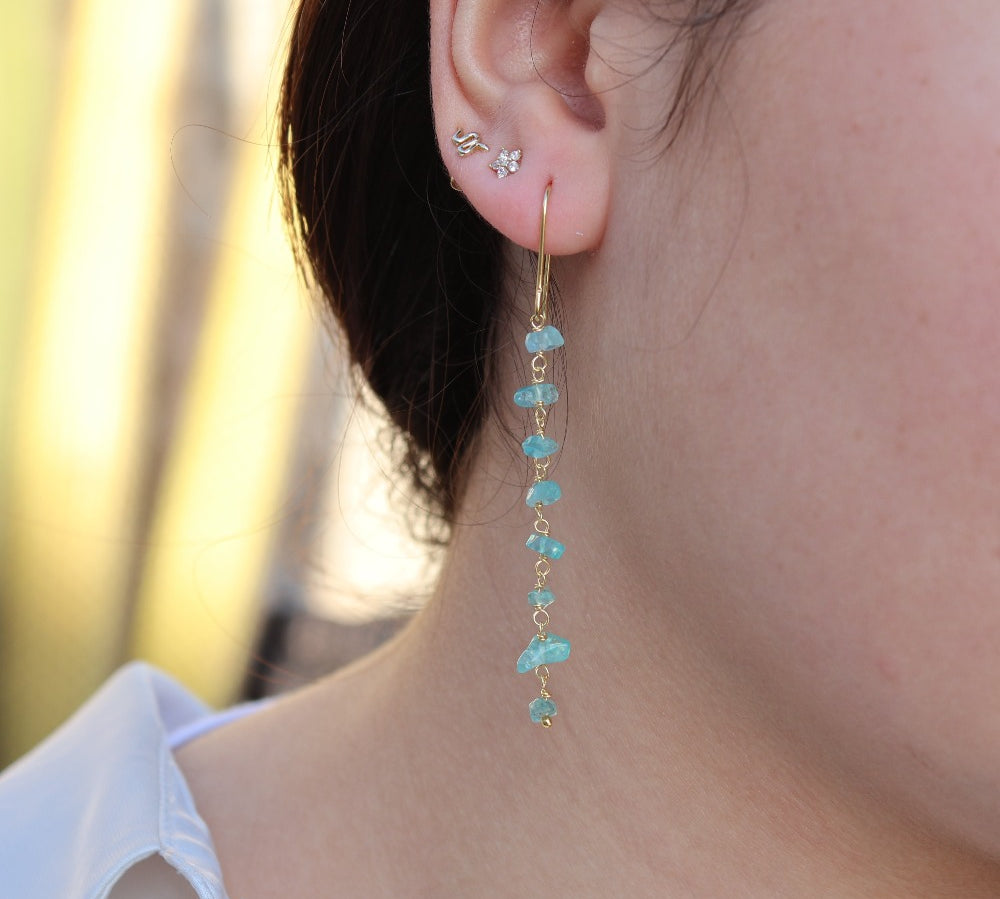 Golden earrings and raw stones