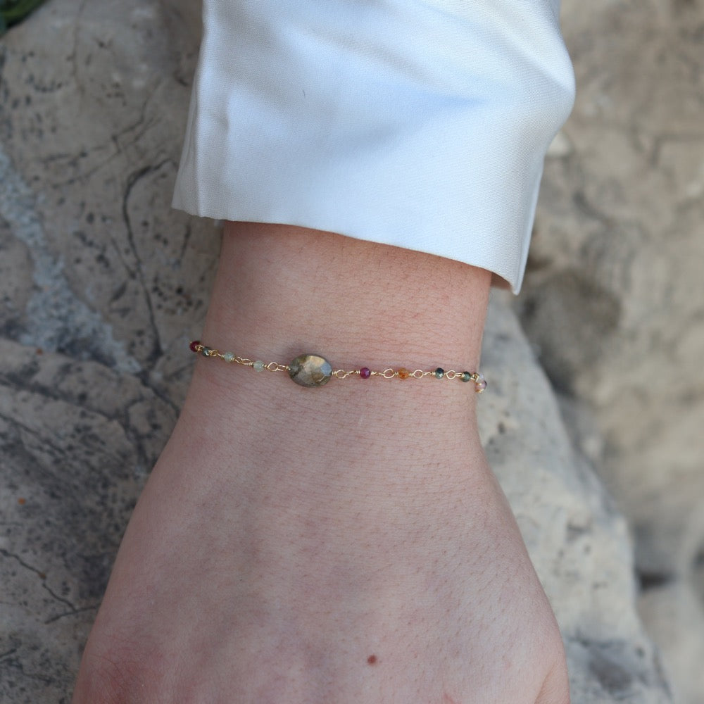 Golden bracelet with faceted stones and small stones