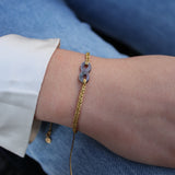 Golden braided bracelet with mother-of-pearl infinity