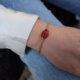 Gold braided cord bracelet and ladybug