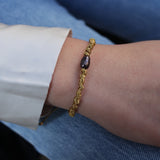 Gold cord bracelet and gray cultured pearl