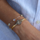Wire bracelet with oval stones and golden discs