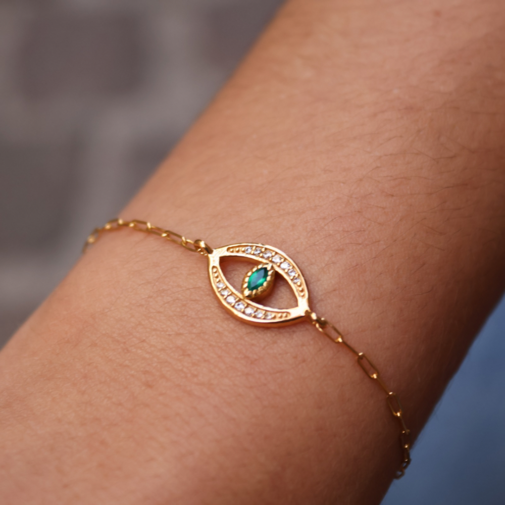 Golden bracelet with lucky eye, stone and zircons