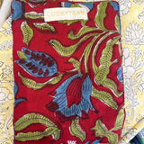 Red jewelry pouch with blue flowers and green interior